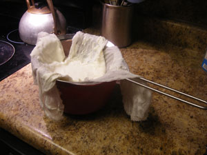 Straining yogurt to make Greek yogurt